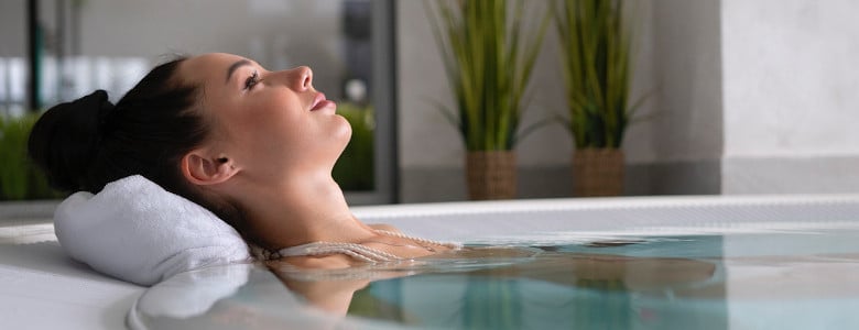 Frau geniesst Bad in einem Indoor-Jacuzzi
